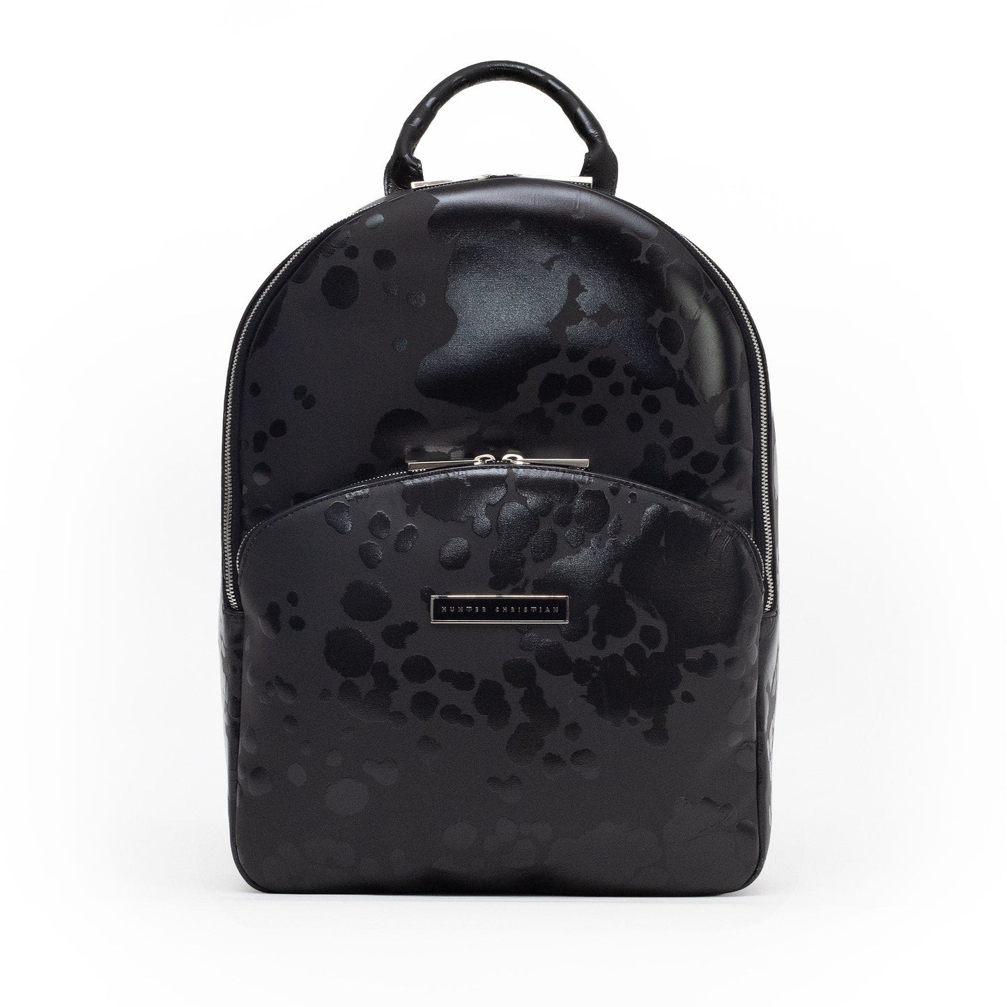 Front view of the Ink Eclipse backpack in matte black Italian leather with gloss-black abstract pattern