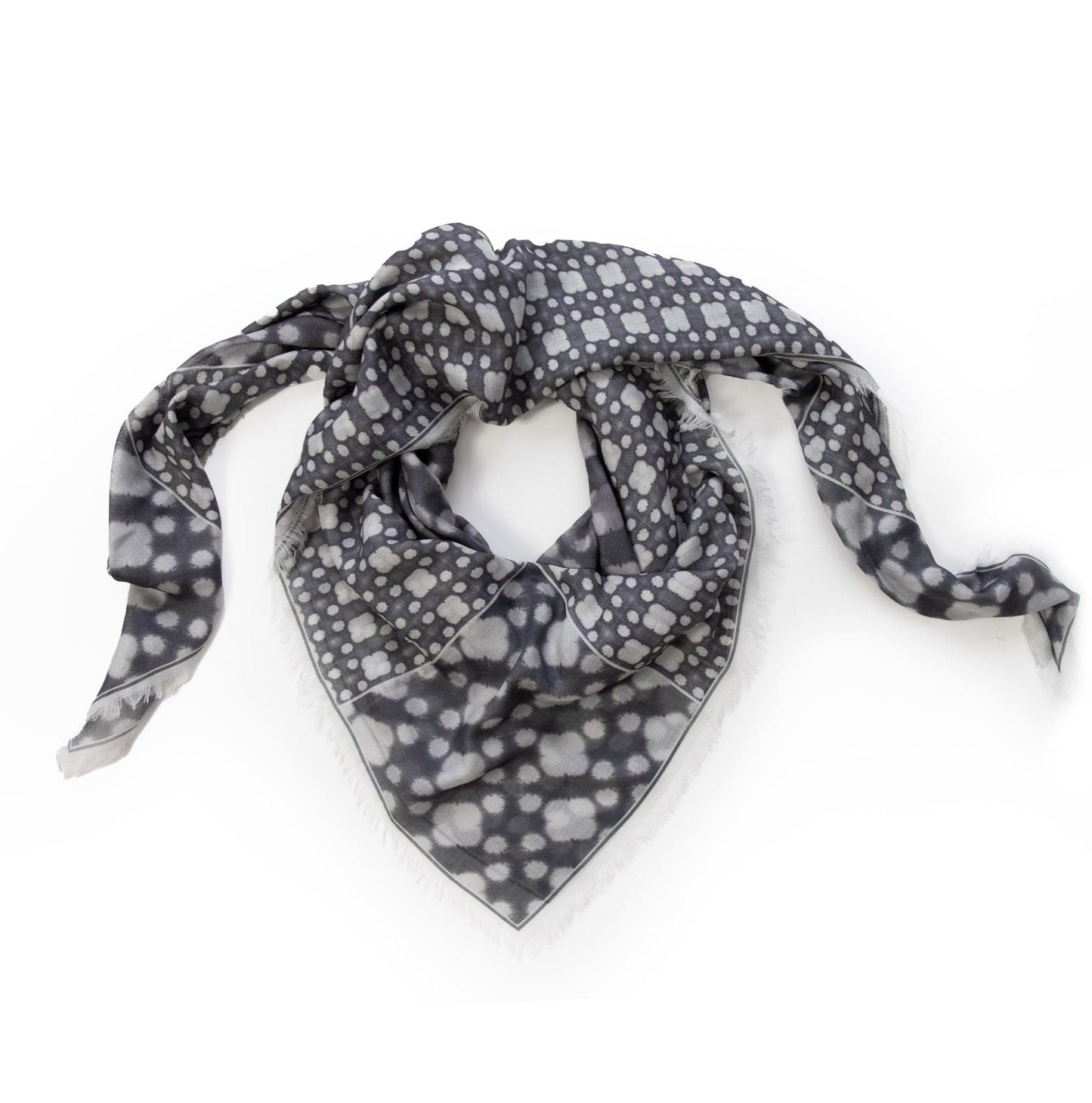 Coiled flat lay of the Aether modal silk scarf, highlighting the airy texture and soft drape of this Italian-made designer accessory