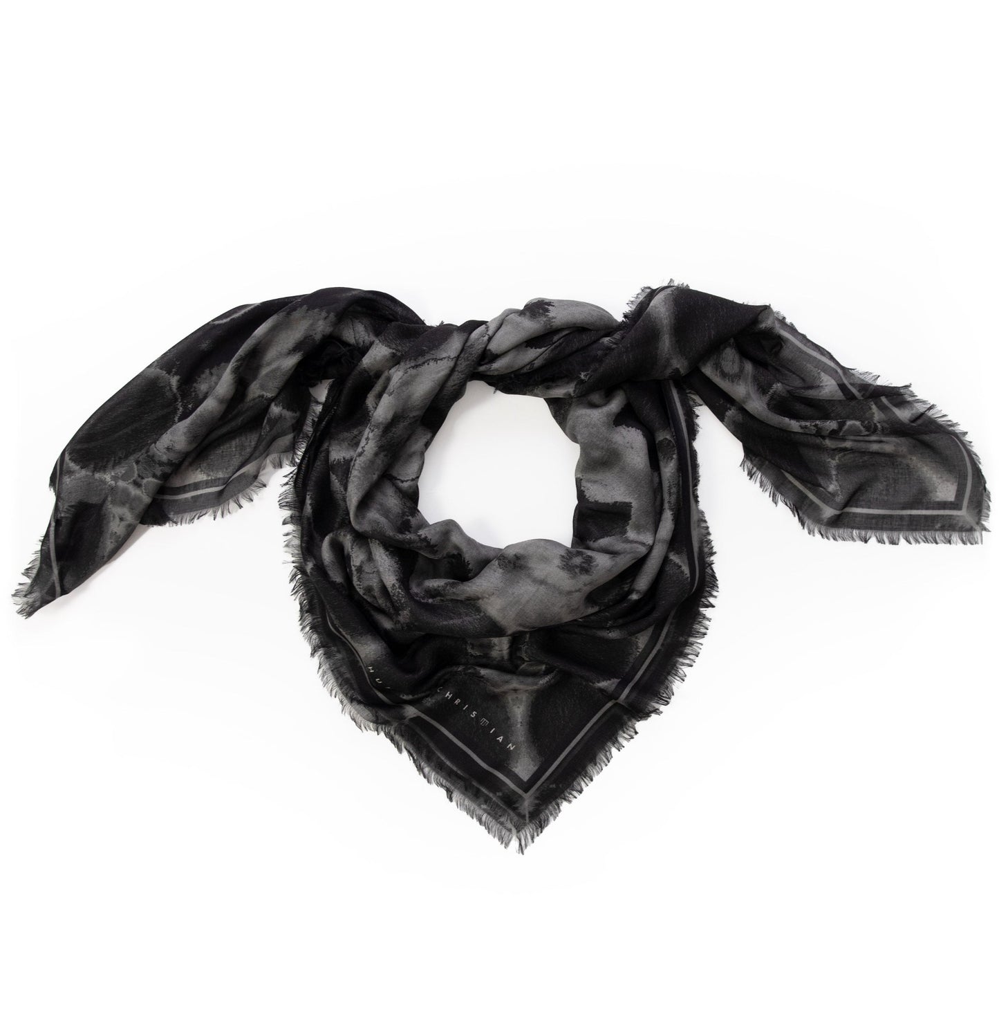 Coiled flat lay of the Erebus scarf by Hunter Christian, in layered black and grey tones with an abstract mist-like print on breathable modal silk