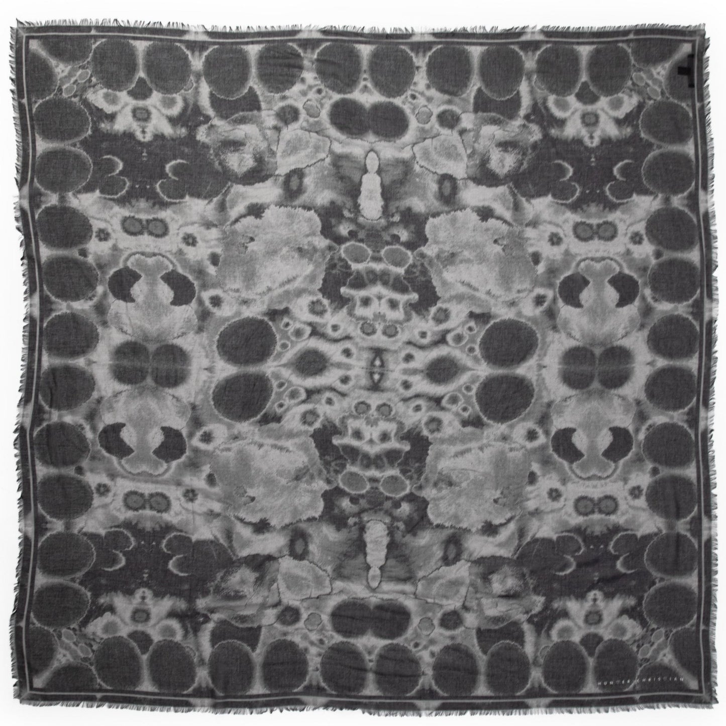 Flat lay of the Erebus scarf by Hunter Christian, featuring a moody black and grey abstract print on Italian modal silk — a statement in quiet luxury and layered texture.