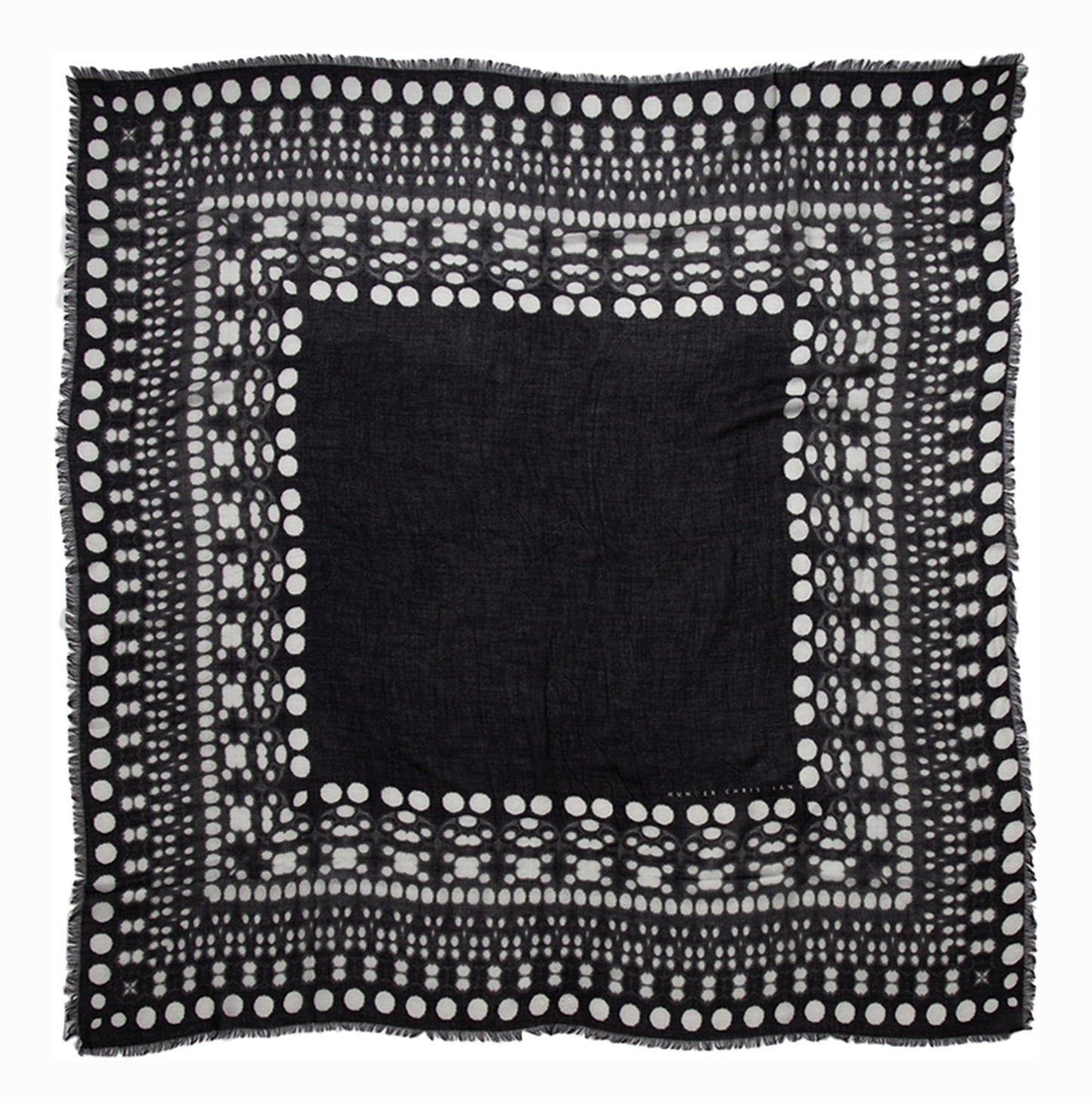Flat lay of Metis Scarf showing full square shape and concentric dot border in black and white