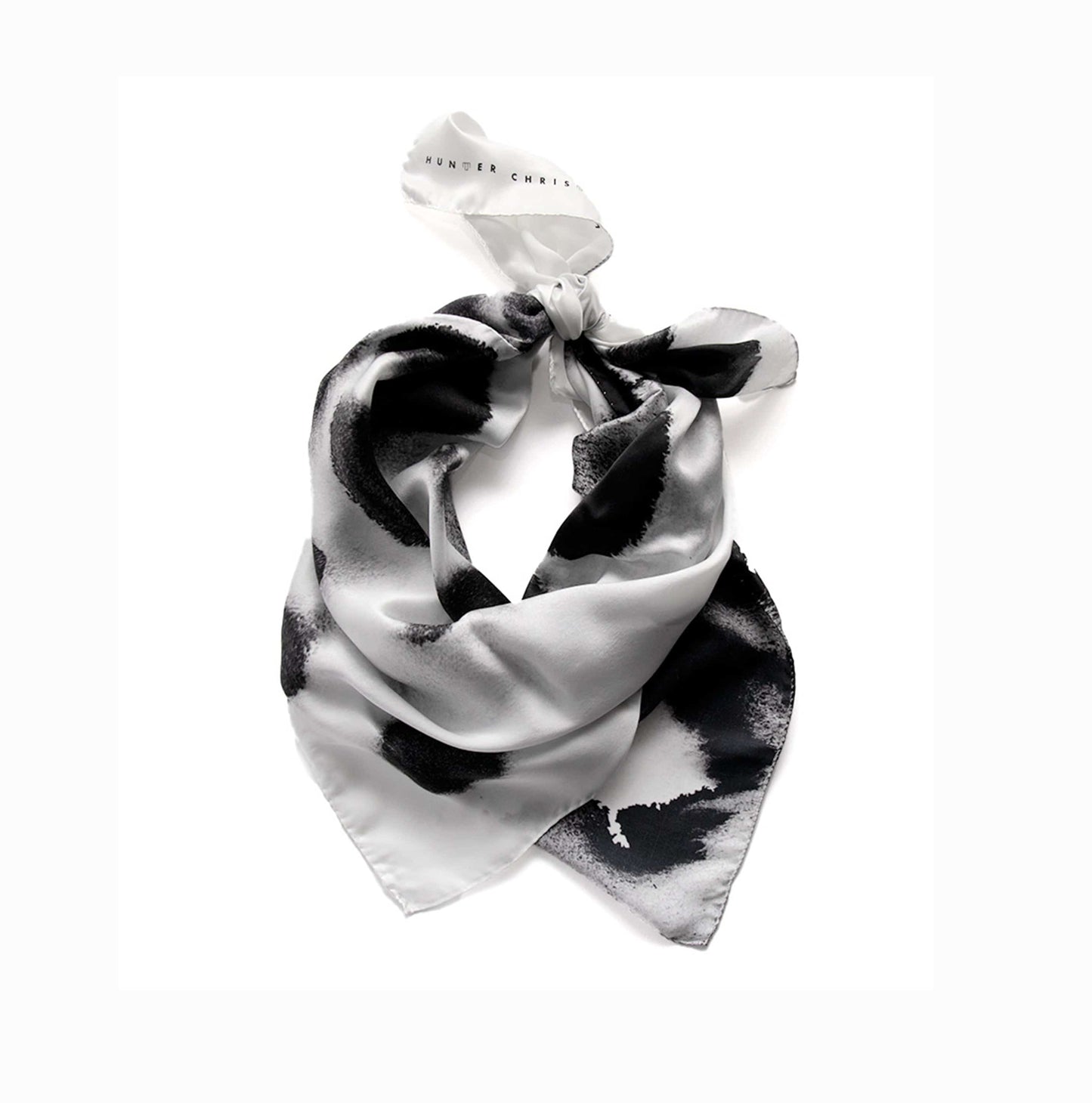 Proteos Scarf coiled to highlight fluid drape and lustrous silk satin texture