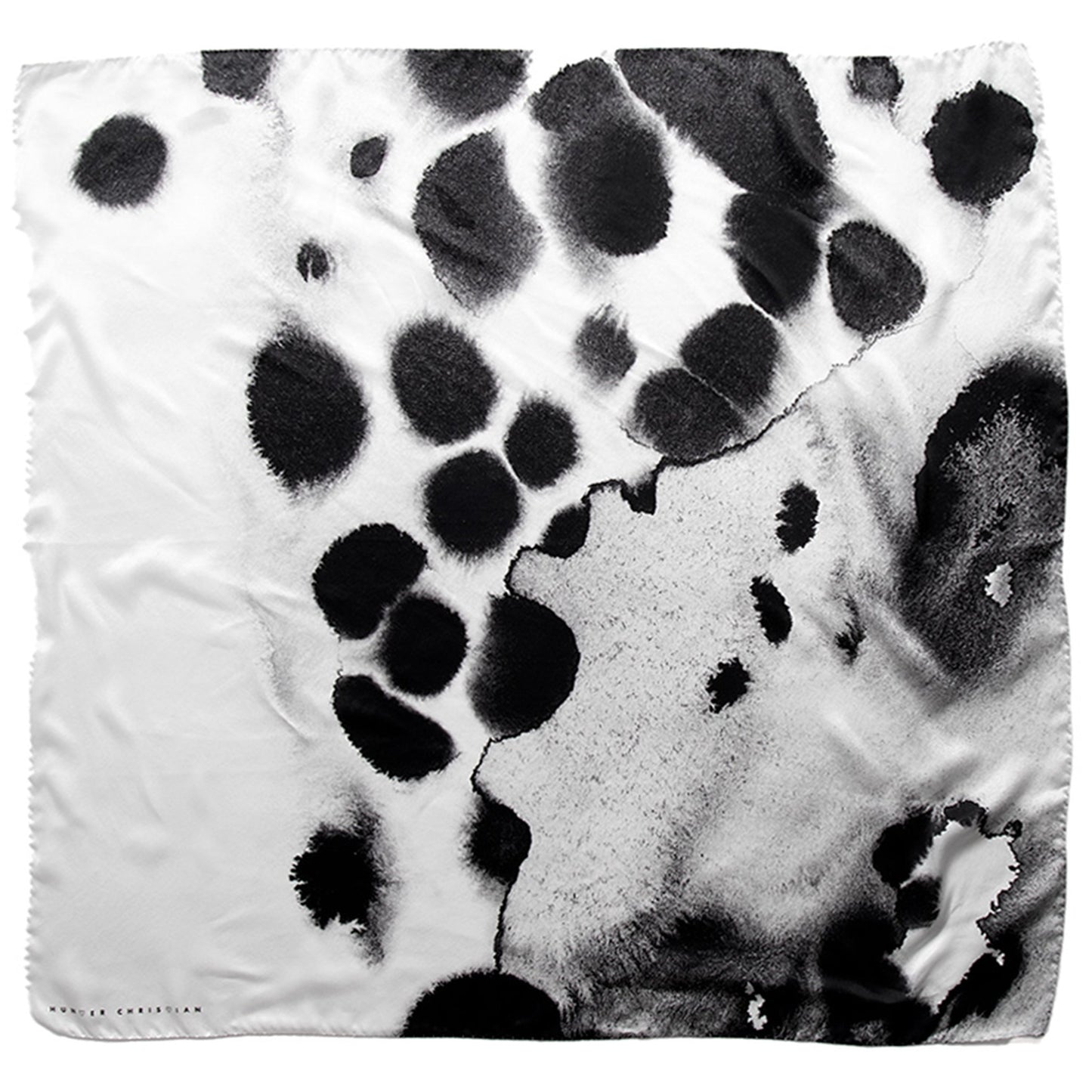 Flat lay of Proteos Scarf showing abstract black and white inkblot-style print on silk satin