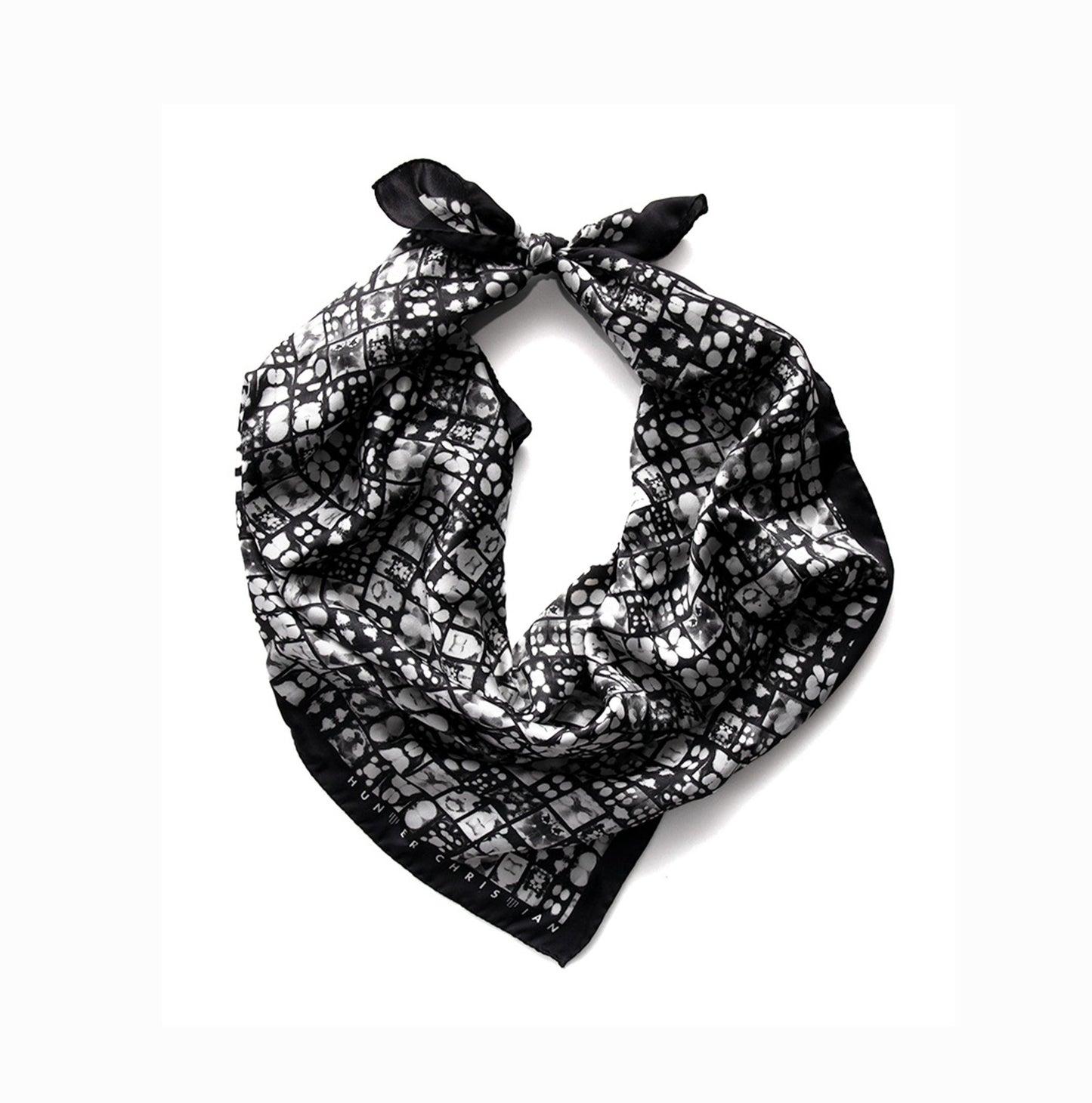 oter Scarf coiled to highlight soft silk satin finish and monochrome ink pattern