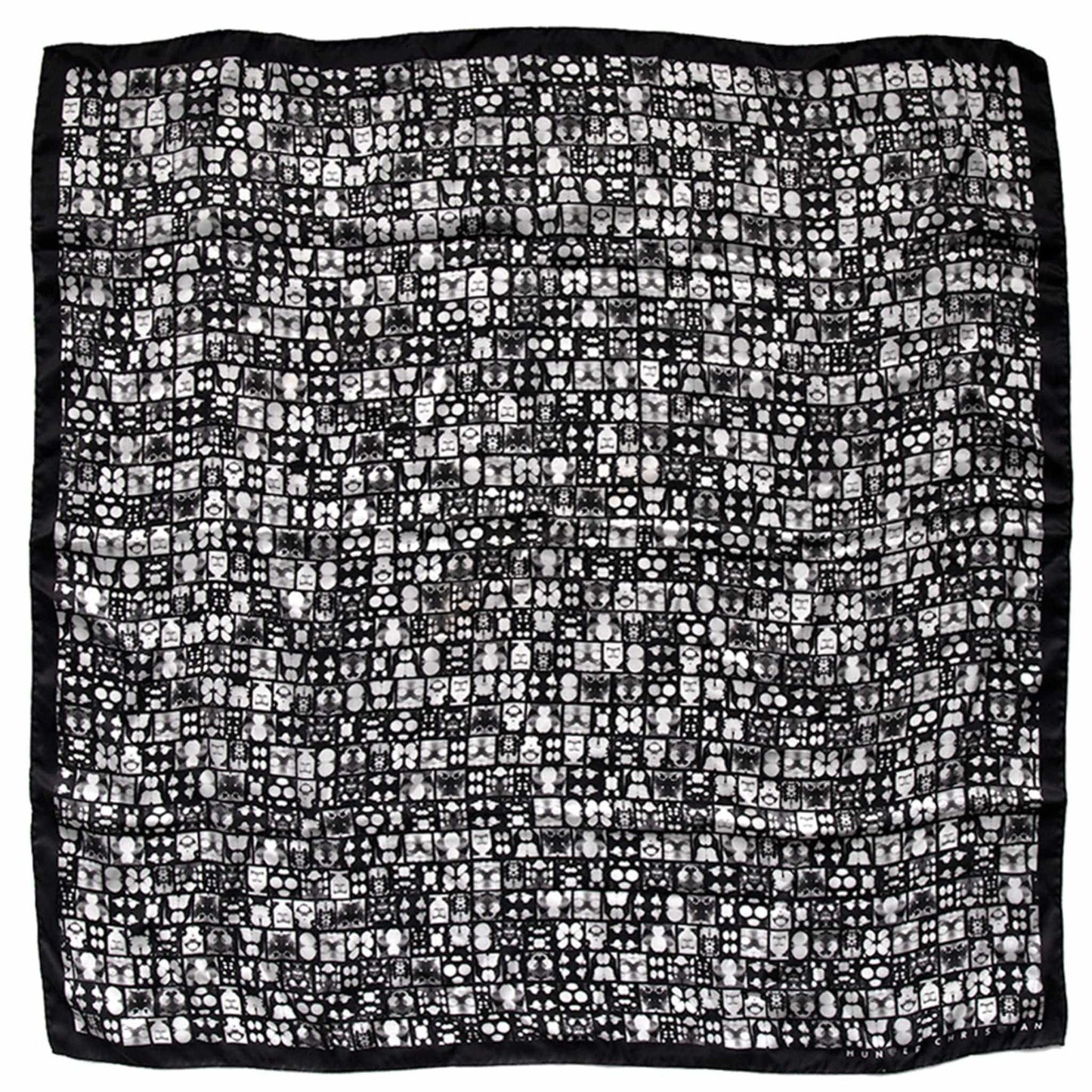 Flat lay of Soter Scarf showing black inkblot grid design with structured geometric rhythm