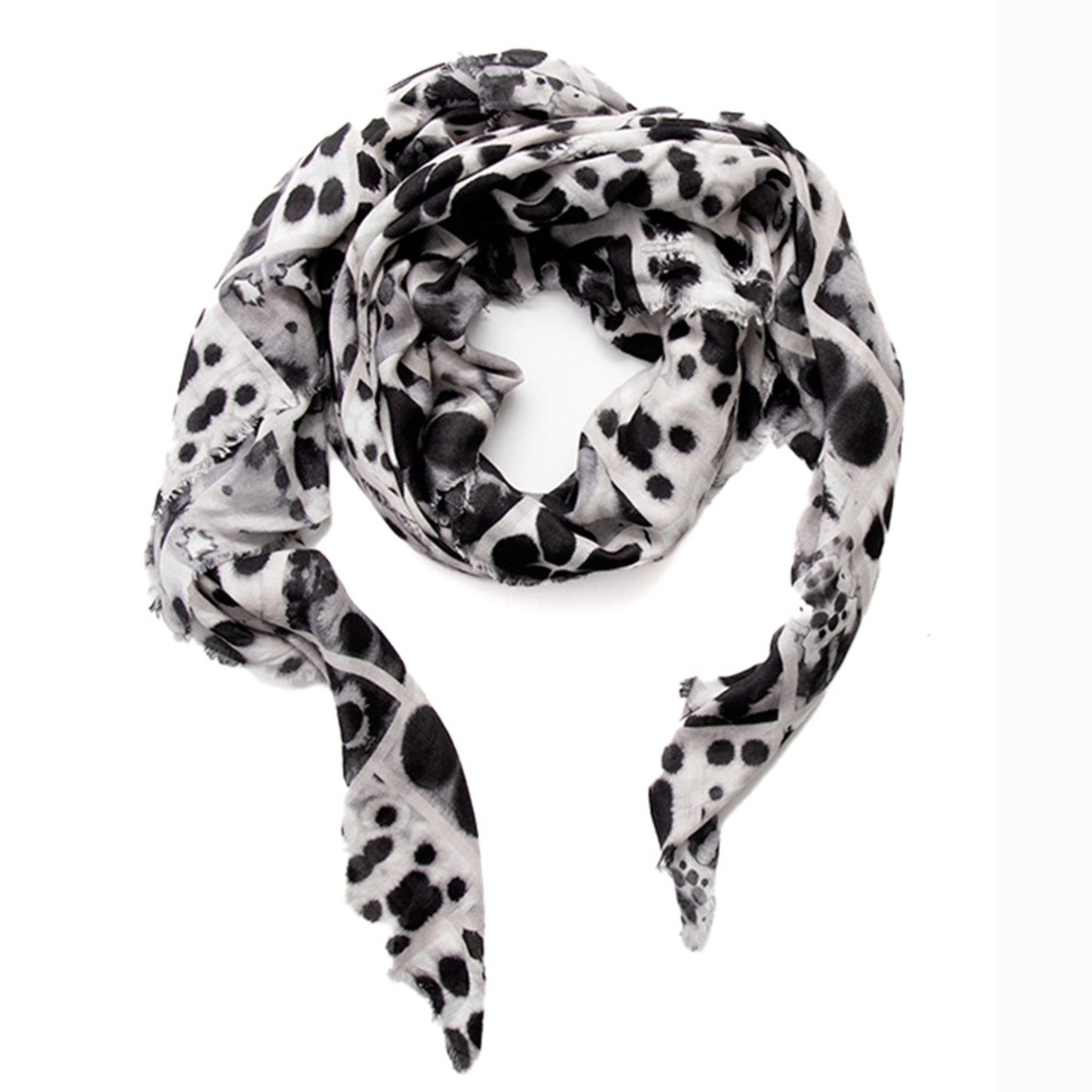 Coiled flat lay of the Soteria scarf by Hunter Christian, revealing the layered inkblot grid pattern in tonal black, grey, and blush on soft Italian vegan modal.
