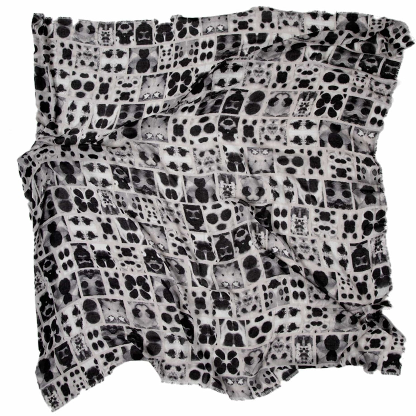 Flat lay of the Soteria scarf by Hunter Christian, showcasing a hand-painted inkblot grid in tones of black, grey, and ivory on soft vegan modal — an abstract print designed to evoke personal interpretation